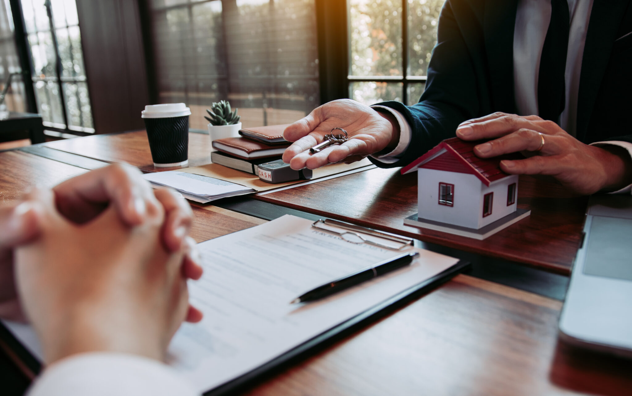 Handing over house keys during a real estate transaction.